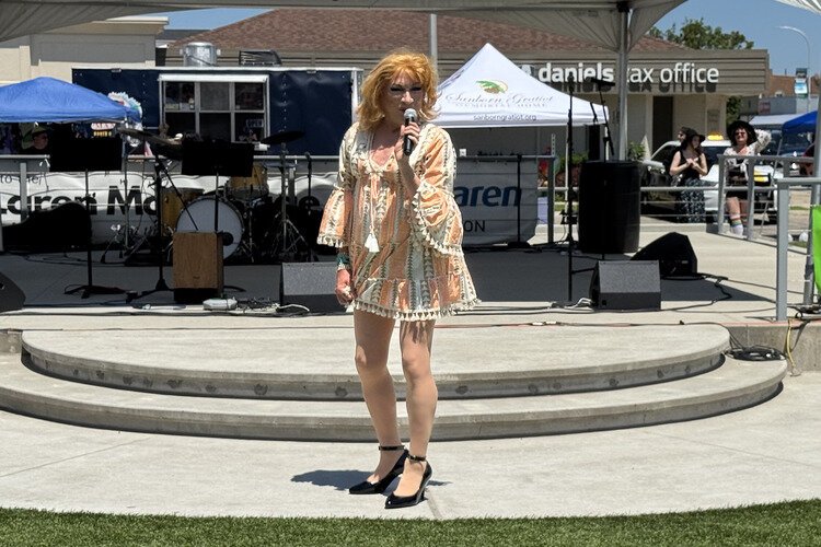 Drag performer Supa Salad welcomes Pride festival attendees.