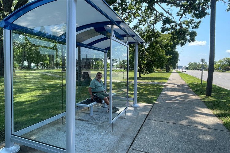 Mike Bica waiting on the number five bus on Pine Grove Avenue.