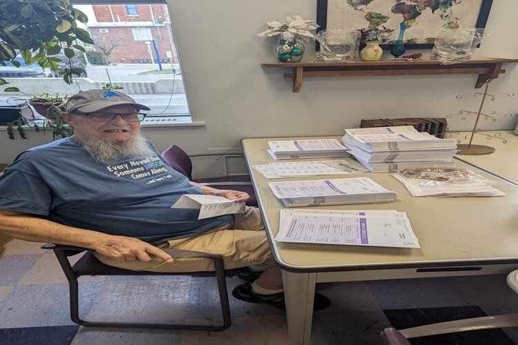 Cecil Harvey volunteers for the Council on Aging by putting address labels on their newsletters.