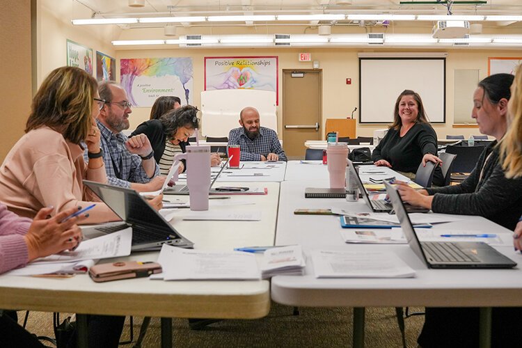 Members of NAMI Blue Water Area meet to discuss upcoming training opportunities to bring to the community.