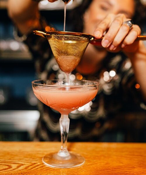 A bartender at Renaissance Man Distillery & Cocktail Lounge makes a Guava Daiquiri.