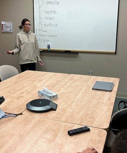 Alexandra Gabridge, DBT and Outpatient Clinician with St. Clair County Community Mental Health, goes over skills with an individual in the Dialectical Behavior Therapy program during a group session.