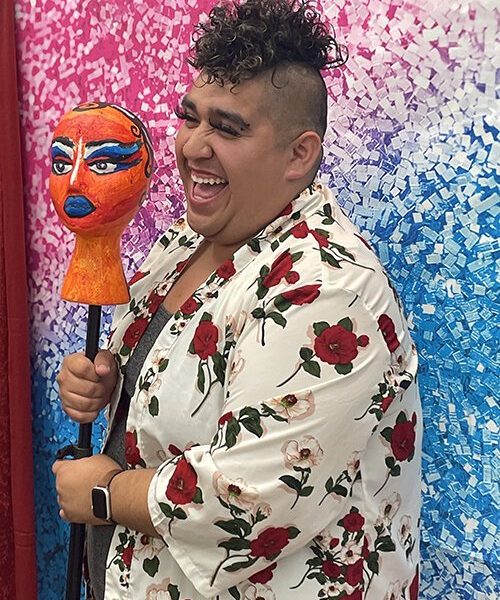 A participant poses for a photo during the Paint n' Sip event on Saturday June 11, 2022.