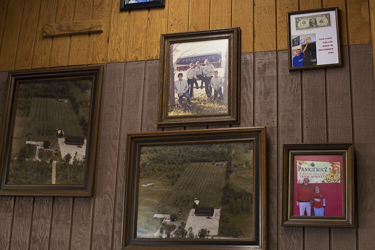 Photos of the property, family, and its first profit hang on the wall at the entrance to the market, located at 10377 Lindsey Rd. in Casco Township.