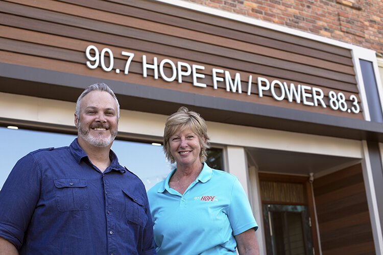Hosts of the "Mornings with Brian & Ellyn" show, Brian Smith and Ellyn Davey, stand outside the radio station located on Military Street in Port Huron, Michigan.