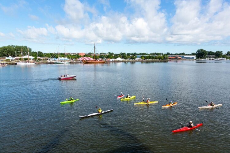 You don’t have to own a power boat to get on the water. Float Paddle Center in Bay City lets you rent a kayak or paddle board. These kayakers were watching the Tall Ship Celebration in 2019. (Photo courtesy of Go Great Lakes Bay.)