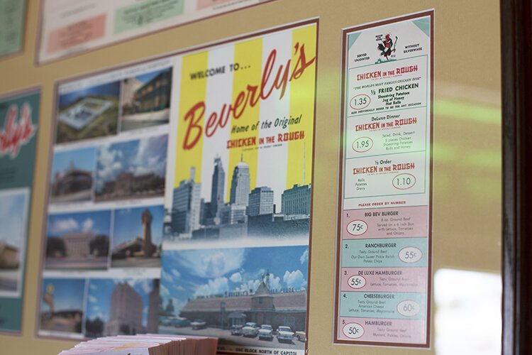 Vintage menus, advertisements, and the history of Chicken in the Rough© are displayed on the walls in the restaurant.