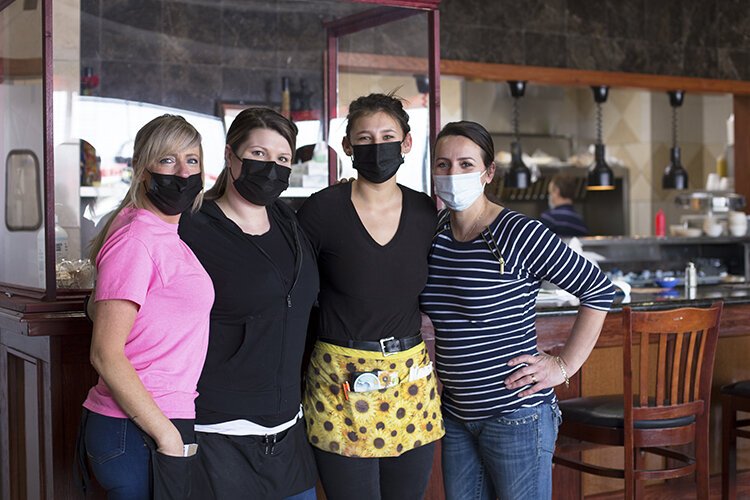 Nick's Four Roses co-owner Laureta Gashaj (right) poses for a photo with (from left) Chrystal Bolden, Kacey Whitenack, and Skye Conrad who work as servers at the restaurant.