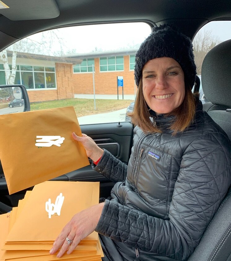 Teachers in Port Huron prepare work packets to send home to students