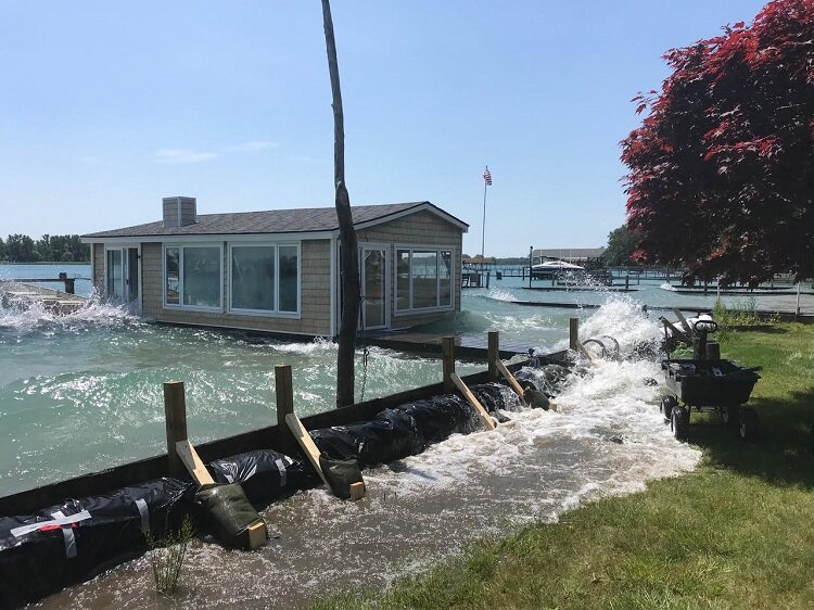 In Clay Township, boats passing by at legal speeds create waves that crash into and over barriers. A bill in the state legislature aims to designate "no wake" zones in high water conditions.