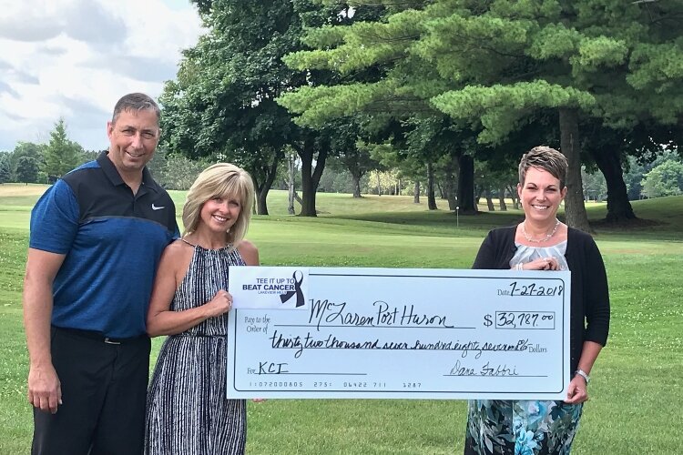 Dennis and Dana Fabbri present a check to the McLaren Port Huron Foundation.
