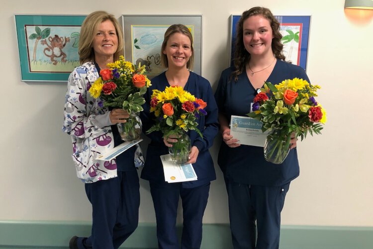 Amy Bolt, Heather Gieleghem and Brittany Kerluke receive a Guardian Angel Award.