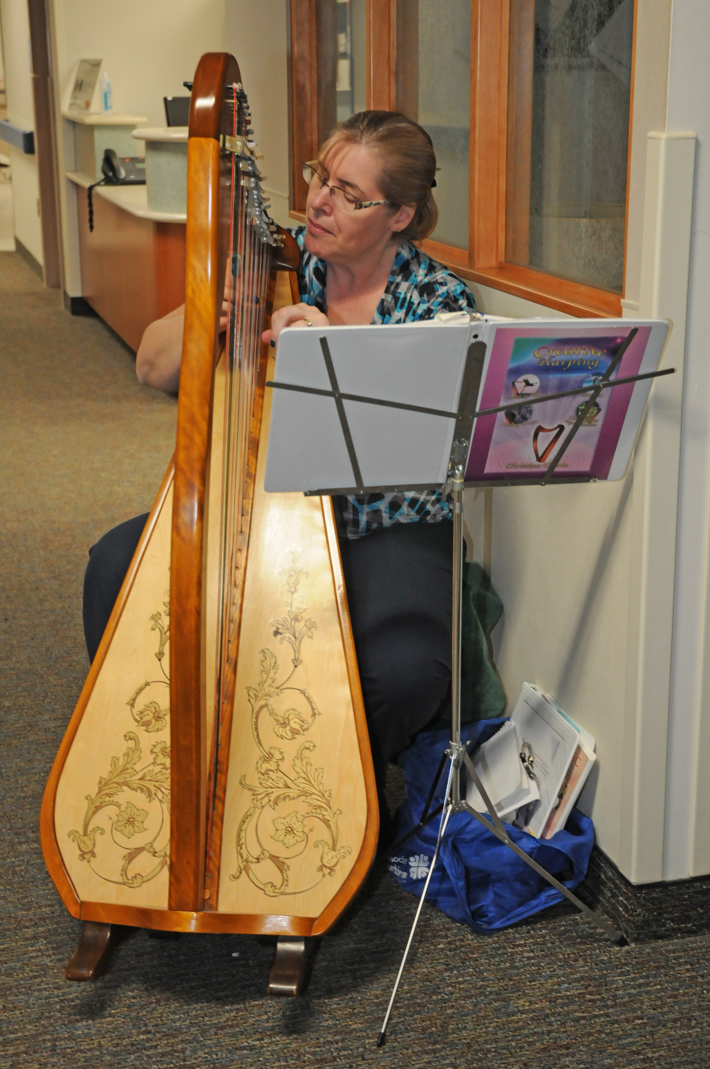 Karen Theume plays the harp in the cancer center lobby and in-patient oncology floor, soothing both patients and their loved ones.