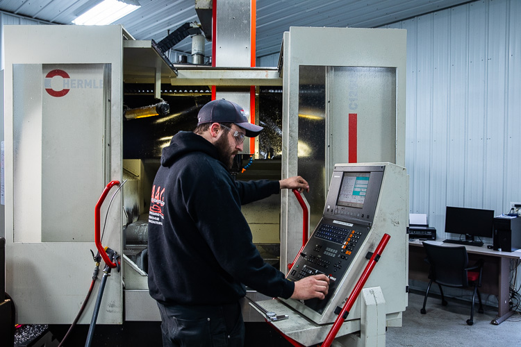 Crew members work at Steve Bartolomucci's shop.