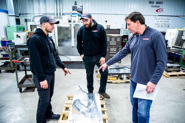 Steve Bartolomucci goes over a product with employees.