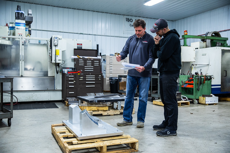 Steve Bartolomucci explains a new process to employees.