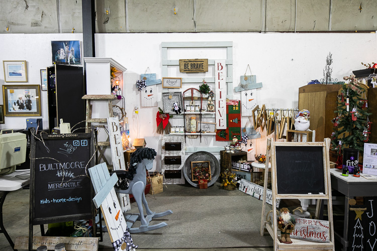 An old-fashioned rocking horse stands among the goods.