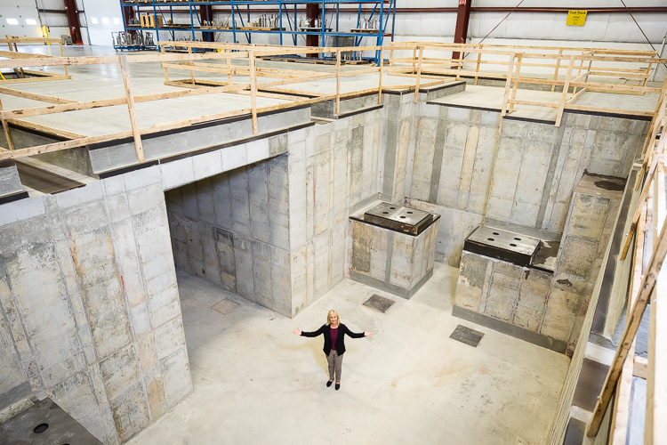 Donna Russell-Kuhr stands on the floor of the plant at PTM Corp.