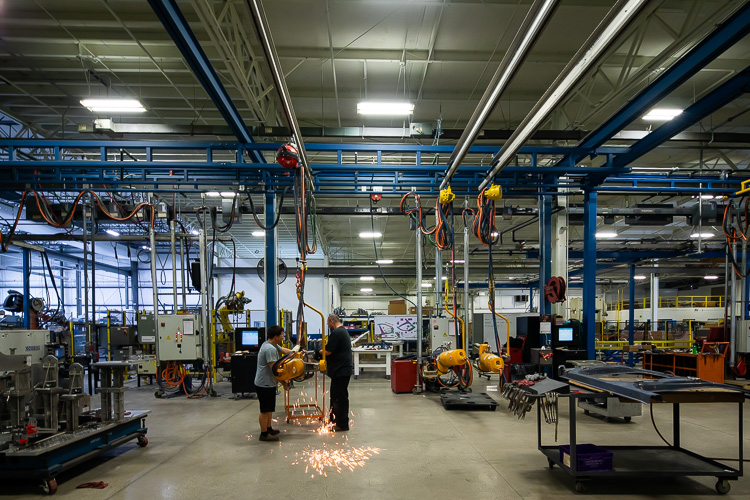 Workers on the floor at PTM Corp.