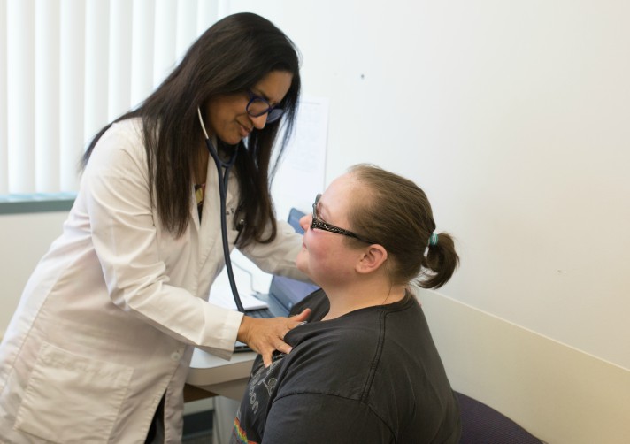 Dr. Sushma ready begins an exam on Magen Chavarria, 25, of Port Huron.