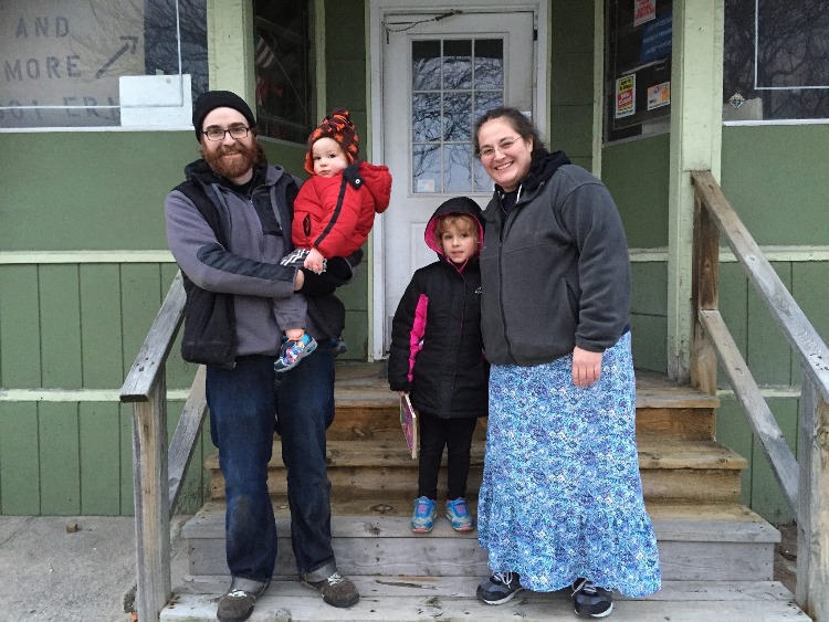 Betsy Selepack and her family outside the storefront the day it was purchased in 2015.