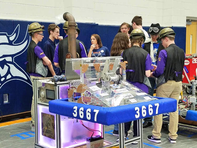 Port Huron Robotics talk with members of the Yale Jiggawattz before a competition.