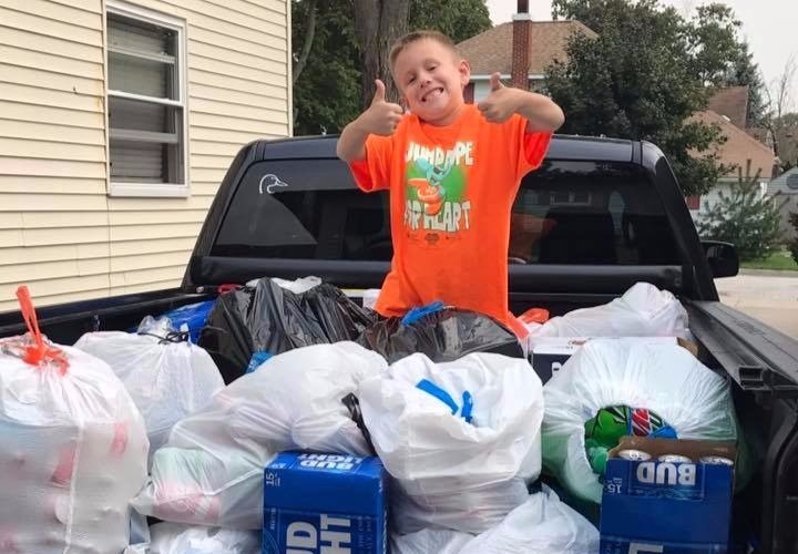 Ryan enjoys helping mom Stacy collect bottles for a hurricane fundraiser.