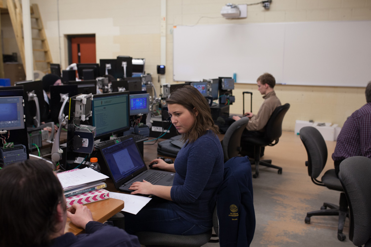 Students work on designing a program to operate the Pick and Pack program.