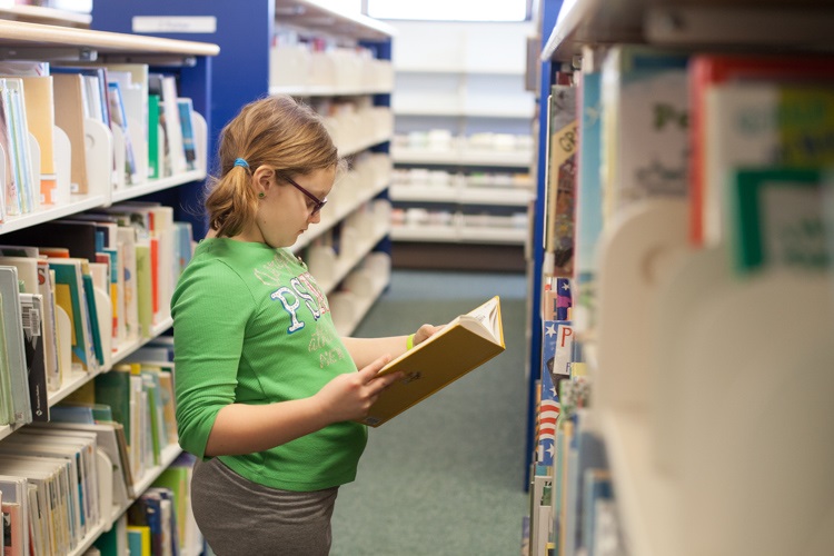 Natalie Turner age 9, of Port Huron. Looking for books to read for the March of Dimes Read-a-thon.