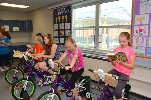 Students enjoy reading and riding together.