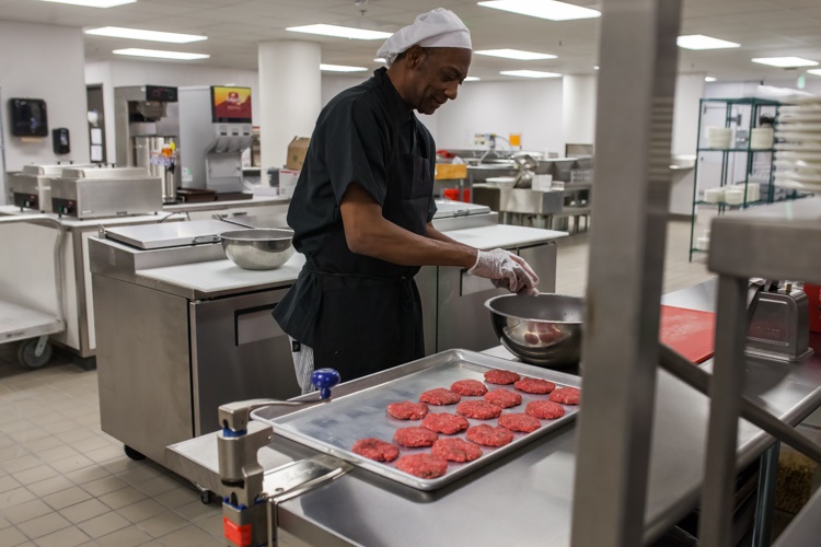 Chefs prepare sliders for the grand opening of a restaurant inside Sperry's Movie House