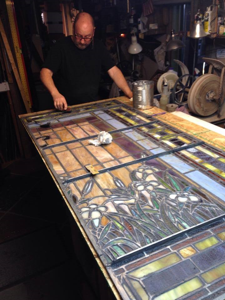 Donny Burton works to restore a stained glass window.
Photo courtesy of Burton Studios Facebook