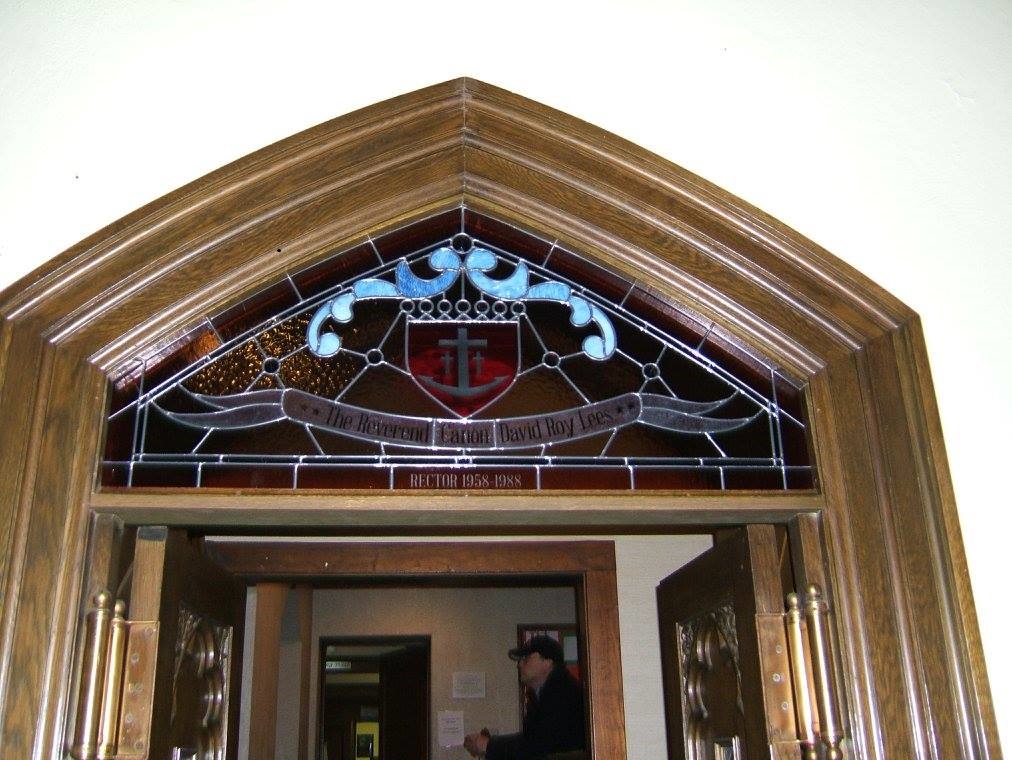 Stained glass restored by Donny Burton hangs above a doorway in church.
Photo courtesy of Burton Studios Facebook