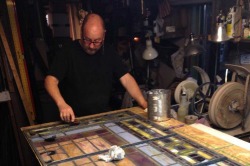 Donny Burton works on the painstaking process of restoring stained glass.