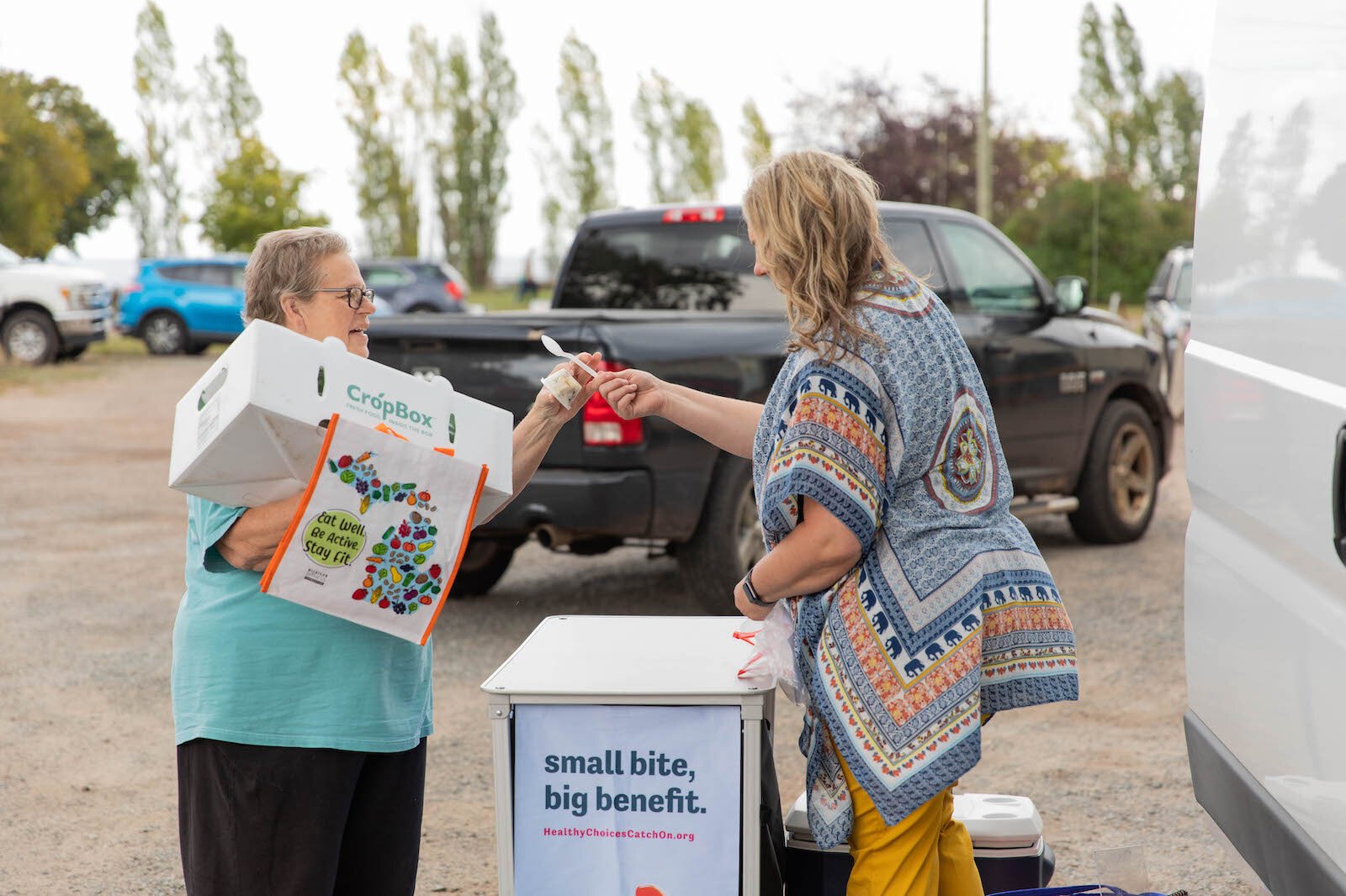 MARESA Nutrition Educator Michelle Granger (right) talks with a CSA member.