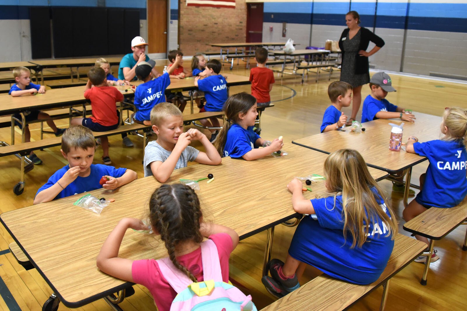 Campers at the YMCA summer day camp at Petoskey's Ottawa Elementary School snack on their formerly mystery fruits and vegetables.