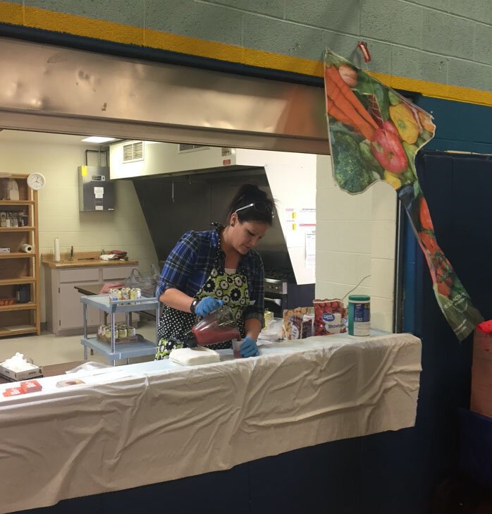 Paula Finfrock, LifeSPAN project director in Eastern Upper Peninsula Intermediate School District, shares a Michigan Harvest of the Month™ recipe at an outreach event at the Kinross Recreation Center. 