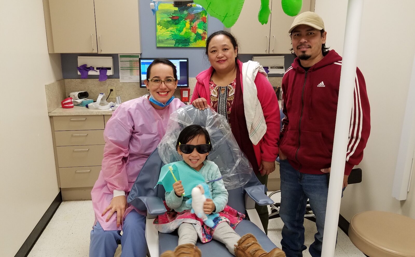A student and her parents following a dental checkup at the Cincinnati Health Department.