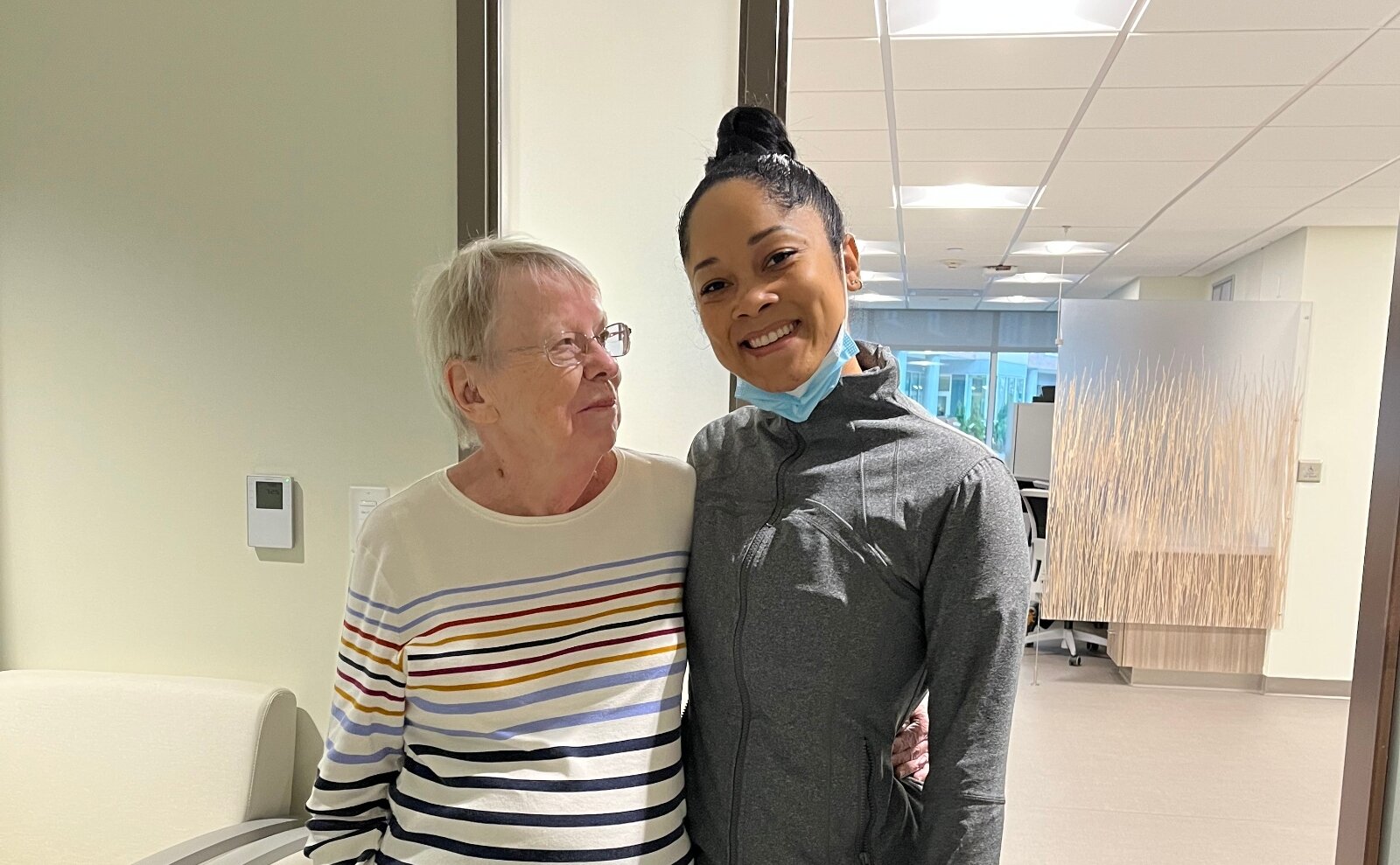 Judy Logan with Ebony, a radiation technician, during a treatment session at Aultman Hospital.