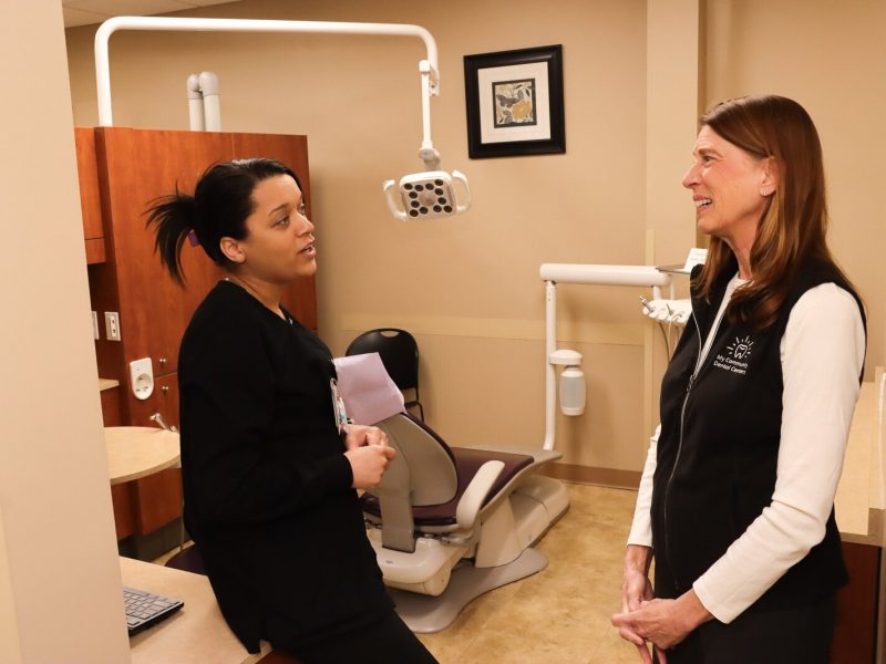 Kimberly Singh (right), Michigan Oral Health Coalition board member and chief community and governmental affairs officer for My Community Dental Centers, chats with Dental Assistant Kortney Jones.