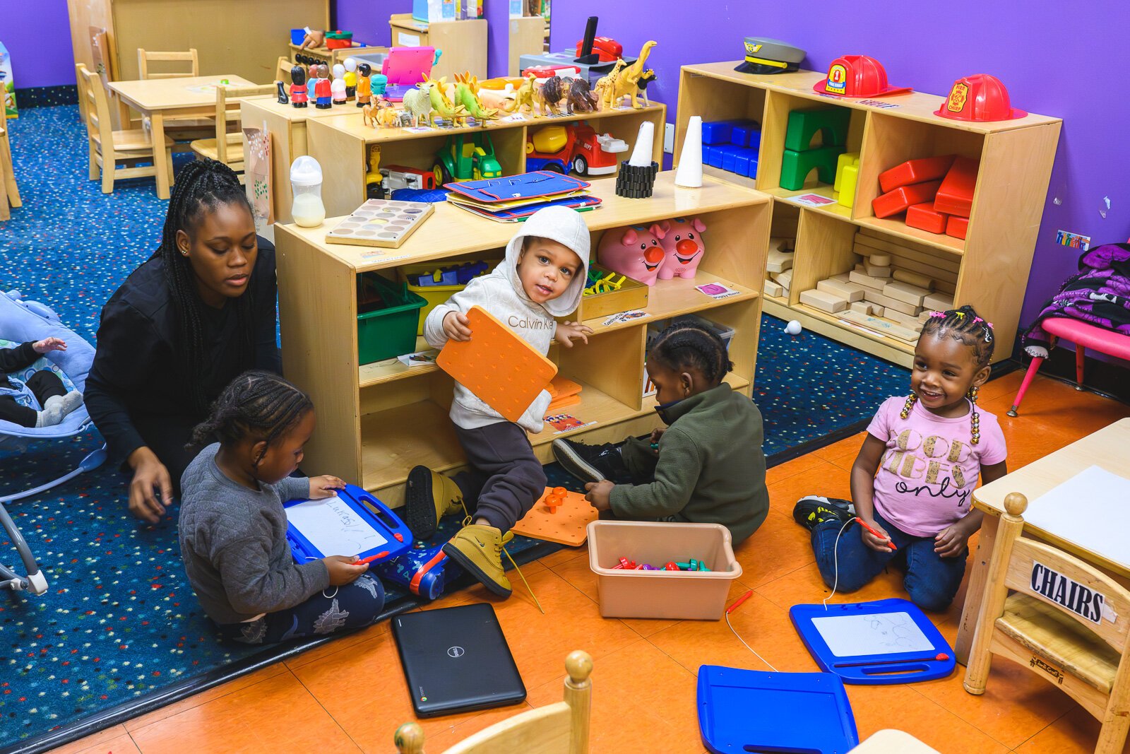 Teacher and children at NEST Child Care and Parent Institute in Detroit