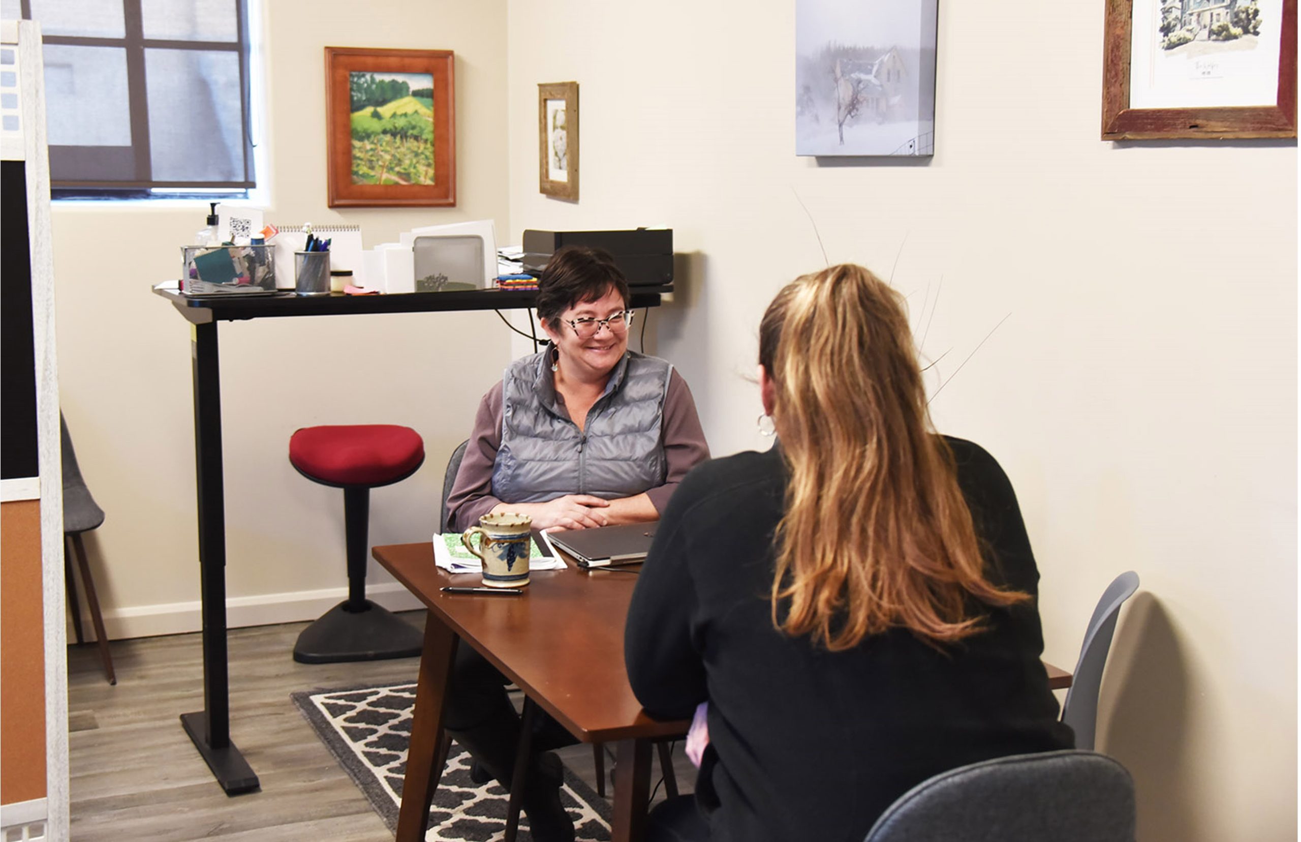 Yarrow Brown chats with a colleague at Housing North's offices.