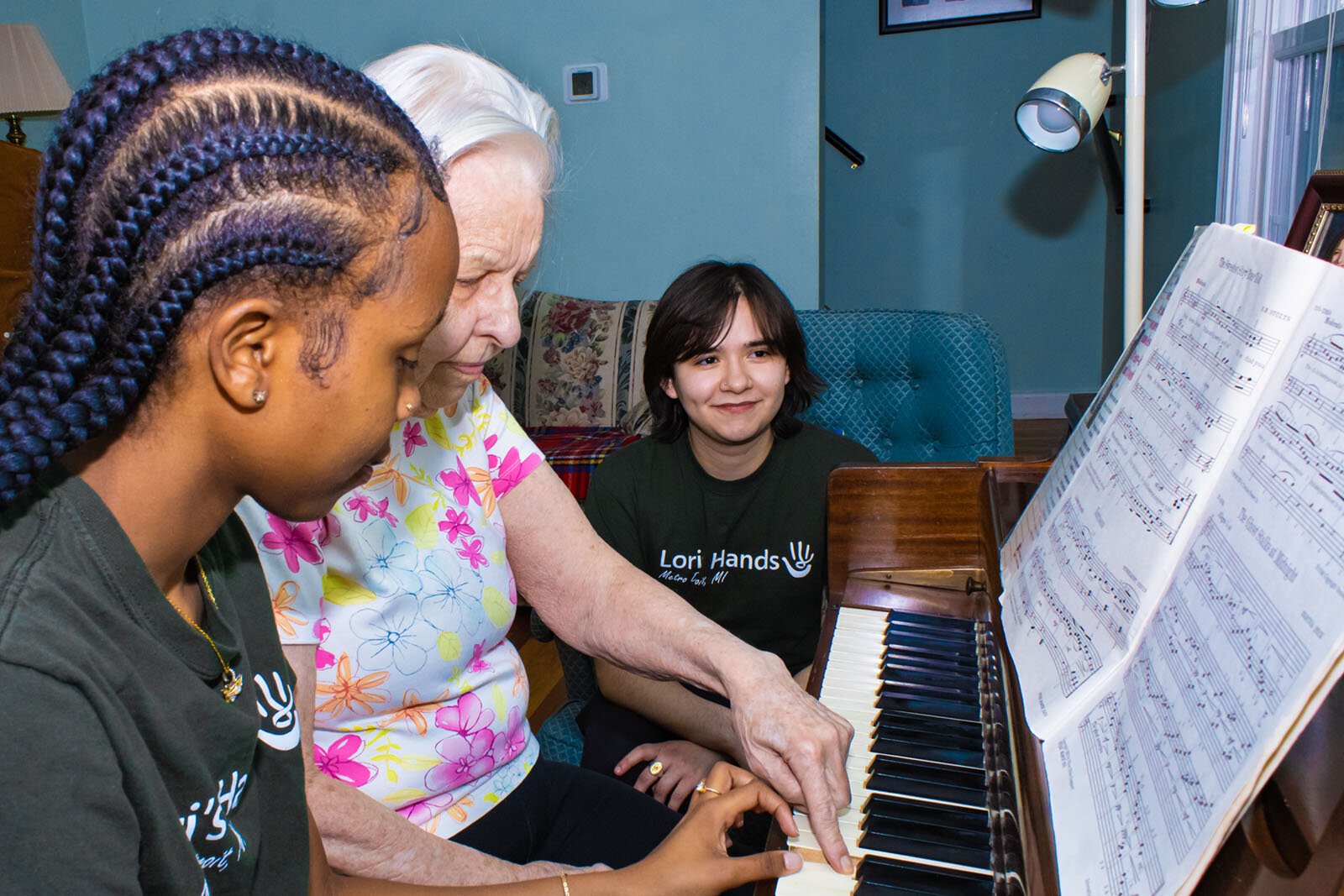 SOCIAL Program volunteers Antonia Gitau and Keen Parra with their client, Janet, at center.