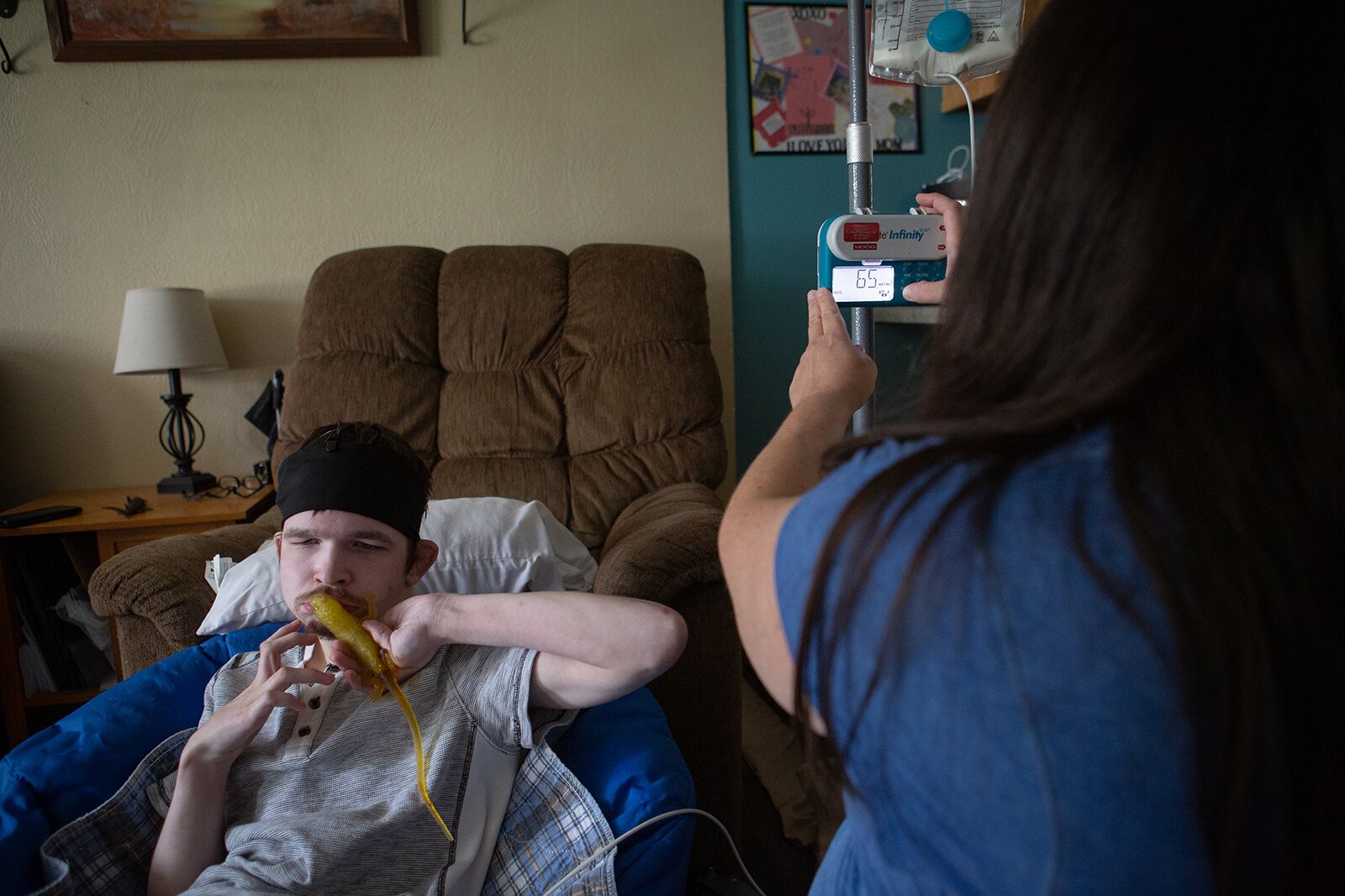Skyler Assman plays with a toy while Krista Assman prepares to feed him.