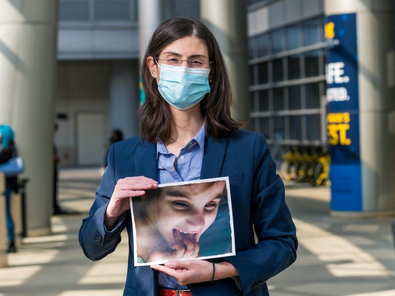 End-of-life doula Toula Saratsis holds a photo of her daughter Angelica, who died at age 7 of a rare genetic disorder.
