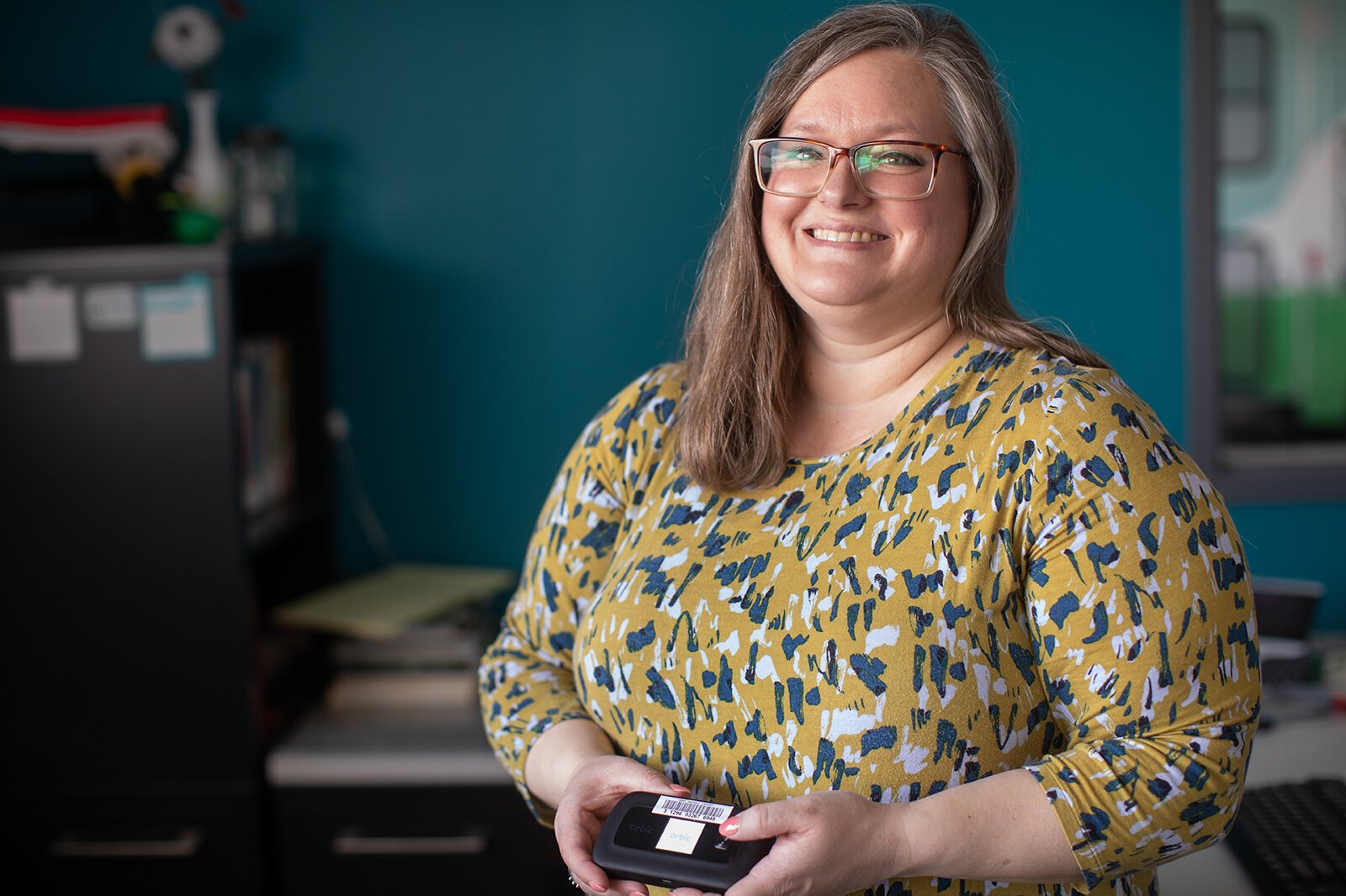Joyanne Huston-Swanson holds a wi-fi hotspot.