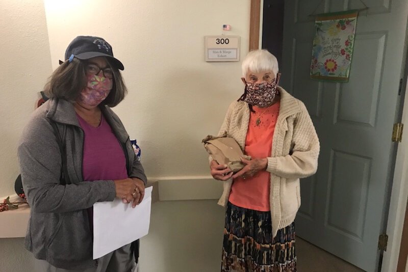 A Meals on Wheels volunteer chats with client Mary.