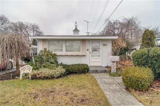 Affectionately called The Doll House, this small home offers great water access.